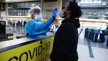 LOS ANGELES, CALIFORNIA - DECEMBER 22: A man receives a nasal swab COVID-19 test at Tom Bradley International Terminal at Los Angeles International Airport (LAX) amid a coronavirus surge in Southern California on December 22, 2020 in Los Angeles, California. The tests are not mandatory with results returned within 24 hours to help travelers avoid quarantining at their destinations. TSA agents screened over 1 million people for three consecutive days last Friday, Saturday and Sunday, the beginning of the traditional holiday travel season, for the first time since the start of the coronavirus pandemic. Mario Tama/Getty Images/AFP 
