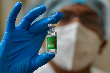 A nurse displays a vial of Covishield, AstraZeneca's Covid-19 coronavirus vaccine made by India's Serum Institute, as she prepares to inoculate her colleagues at the KC General hospital in Bangalore on January 16, 2021.