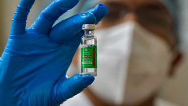 A nurse displays a vial of Covishield, AstraZeneca's Covid-19 coronavirus vaccine made by India's Serum Institute, as she prepares to inoculate her colleagues at the KC General hospital in Bangalore on January 16, 2021. 