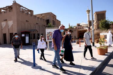Israeli tourists, mask-clad due to coronavirus, visit al-Fahidi Historical Neighborhood of Dubai on January 11, 2021. (Karim Sahib/AFP)