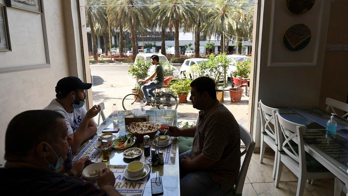 People sit at restaurant in Dubai on May 26, 2020 as the Gulf emirate moved to ease their lockdown measures amid the coronavirus pandemic. (Karim Sahib/AFP)