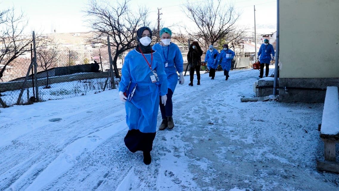Medics from Turkey’s Health Ministry arrives to administer a dose of the CoronaVac vaccine to a person over 90, in Golbasi, in Ankara province, Turkey, Jan. 19, 2021. (Turkish Health Ministry via AP)