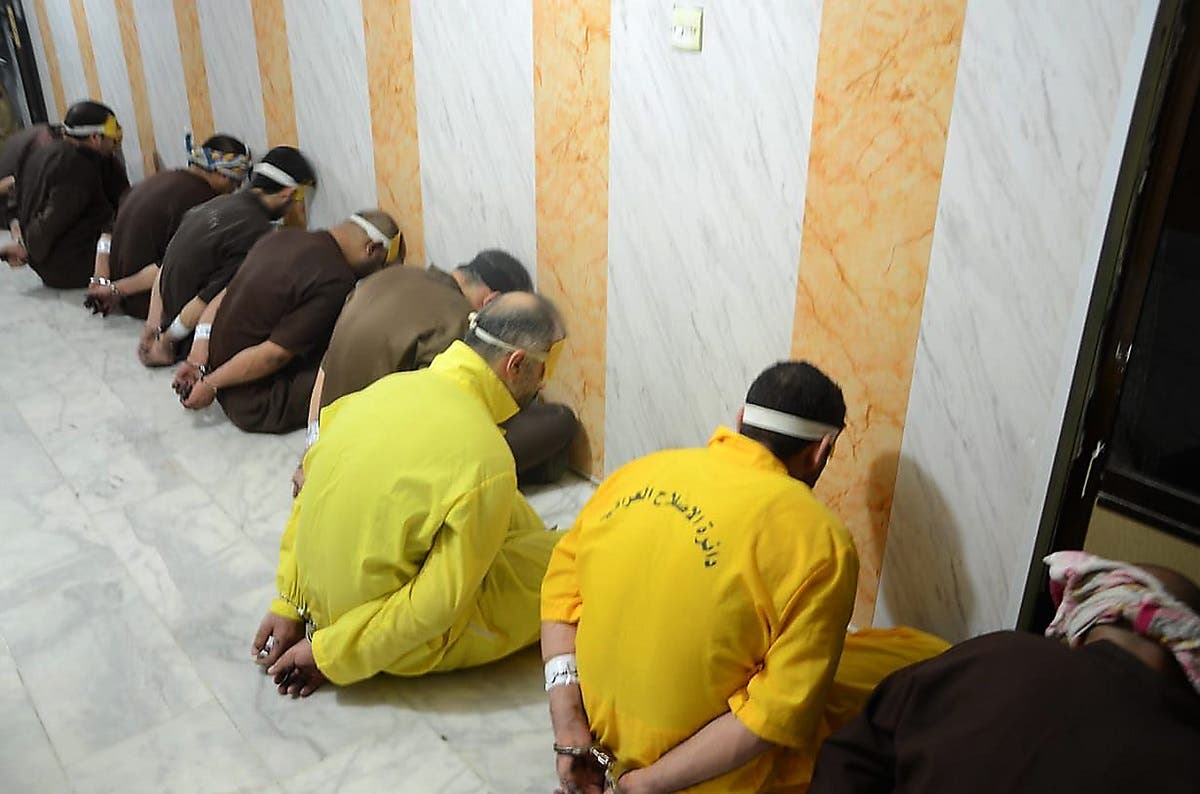 This handout file picture released by the Iraqi Justice Ministry on June 29, 2018 shows blindfolded and handcuffed extremists of ISIS who have been condemned to death waiting for their sentences to be executed. (Iraq Justice Minister/AFP)