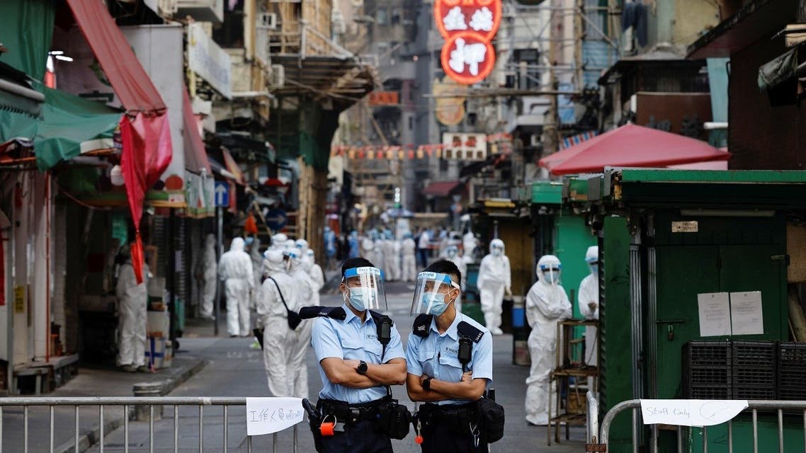 Police and health workers stand in protective gear inside a locked down portion of the Jordan residential area to contain a new outbreak of the coronavirus disease (COVID-19), in Hong Kong, China January 23, 2021. (Reuters)