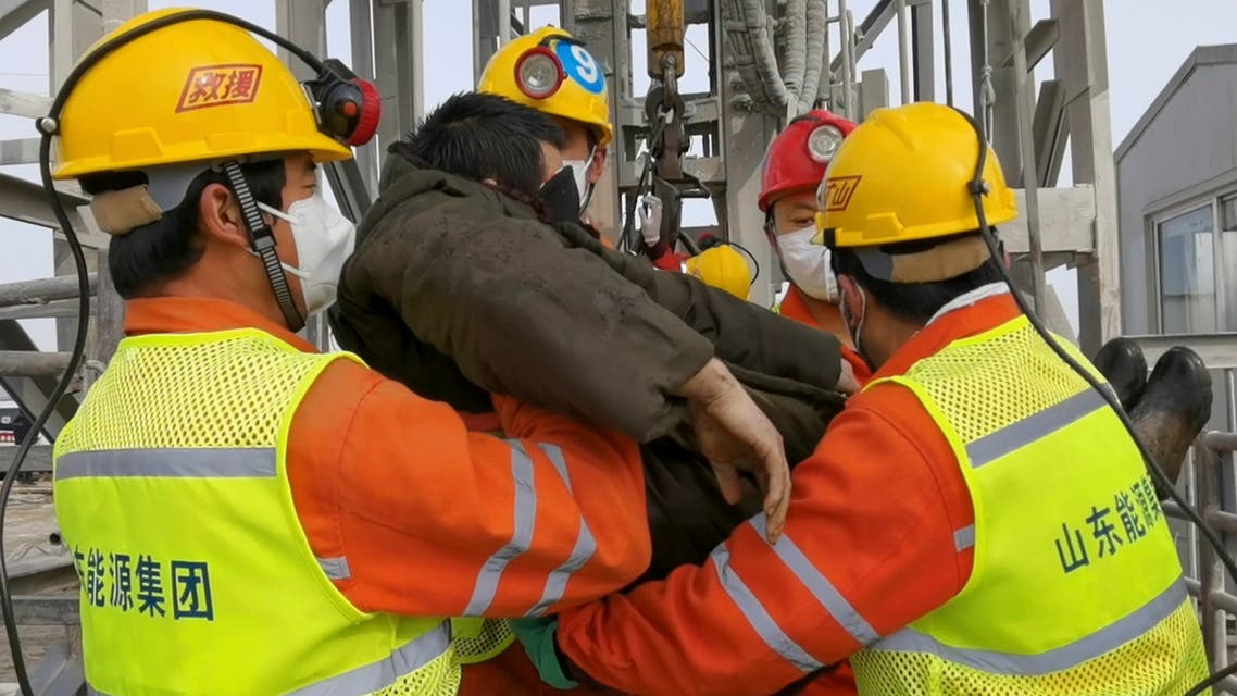 Rescuers carry a miner who was trapped in a gold mine in Qixia City in east China's Shandong Province on Jan. 24, 2021. (AP)