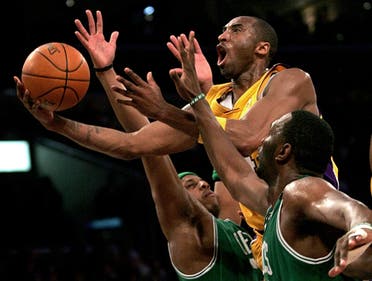 Kobe Bryant, top, goes up for a shot between the Boston Celtics' Paul Pierce, left, and Al Jefferson during the first half of an NBA basketball game in Los Angeles, Feb. 23, 2006. (AP)