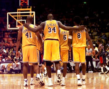 In this Feb. 5, 1999, file photo, Los Angeles Lakers center Shaquille O'Neal (34) puts his arms around teammates, Elden Campbell (41) and Kobe Bryant (8) as Eddie Jones (6) and Derek Harper . (AP)