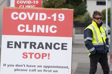 This file photo taken on April 20, 2020 shows a security guard standing outside a COVID-19 coronavirus clinic in Lower Hutt, near Wellington.