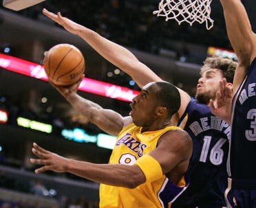 Kobe Bryant puts up a shot around Memphis Grizzlies' Pau Gasol, of Spain, during the first half of an NBA basketball game Wednesday, Dec. 28, 2005. (AP)