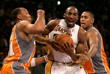 Kobe Bryant, center, is guarded by Phoenix Suns' Shawn Marion, left, and Boris Diaw during the first half of their Western Conference playoff basketball game in Los Angeles, Sunday, April 29, 2007. (AP)