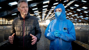 Denmark's Prime Minister Mette Frederiksen (R) and mink breeder Peter Hindbo visit the closed and empty farm near Kolding, Denmark. (AFP)