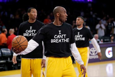 Kobe Bryant, center, and his teammates warm up before an NBA basketball game against the Sacramento Kings, Tuesday, Dec. 9, 2014, in Los Angeles. (AP)