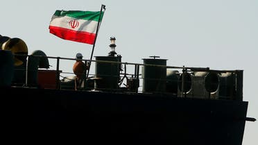 A crew member raises the Iranian flag on Iranian oil tanker Adrian Darya 1 in the Strait of Gibraltar, Spain, August 18, 2019. (Reuters)