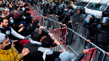 Demonstrators face police officers during a demonstration in Tunis on Jan. 23, 2021. (AP)