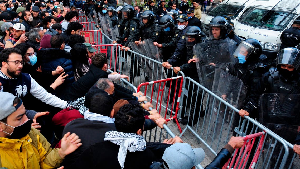 Demonstrators face police officers during a demonstration in Tunis on Jan. 23, 2021. (AP)