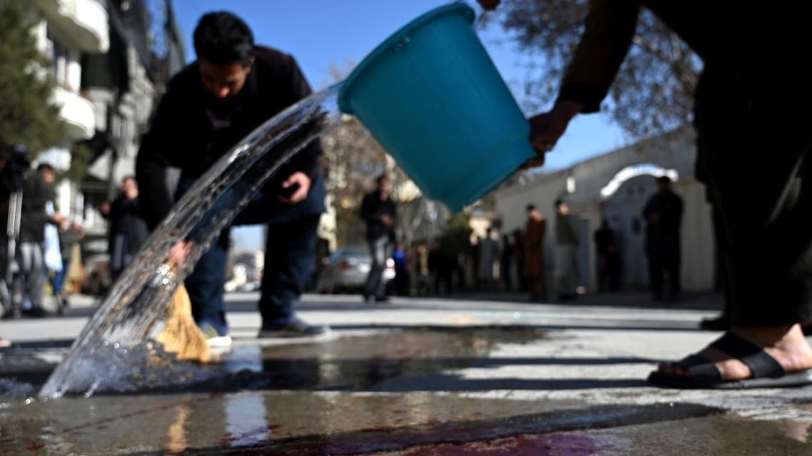Residents wash a road following gunmen shot dead two Afghan women judges working for the Supreme Court, in Kabul on January 17, 2021. (Wakil Kohsar/AFP)