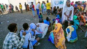 Ethiopian refugees, who fled the Tigray conflict, gather to receive aid at the Tenedba camp in Mafaza, eastern Sudan on January 8, 2021, upon their arrival at the camp from the reception center. (AFP)