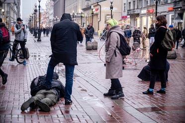 A policeman dressed in civilian clothes holds down a journalist who was filming opposition activist Pavel Krysevich during his action in support of Russian opposition leader Alexei Navalny and against the mass arrests at Saturday's uncoordinated rally in Moscow, Russia, Sunday, Jan. 24, 2021. (AP)