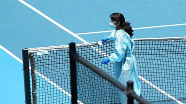 A staff member wearing PPE works to clean surfaces at Melbourne Park in Melbourne. (Reuters)