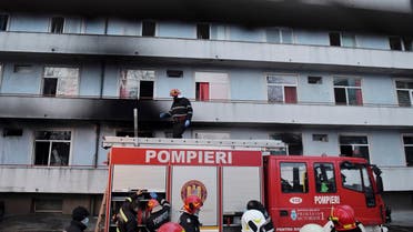 A firefighter stands on top of a fire engine outside a hospital after a fire broke out on the ground floor Friday Jan. 29, 2021. (AP)