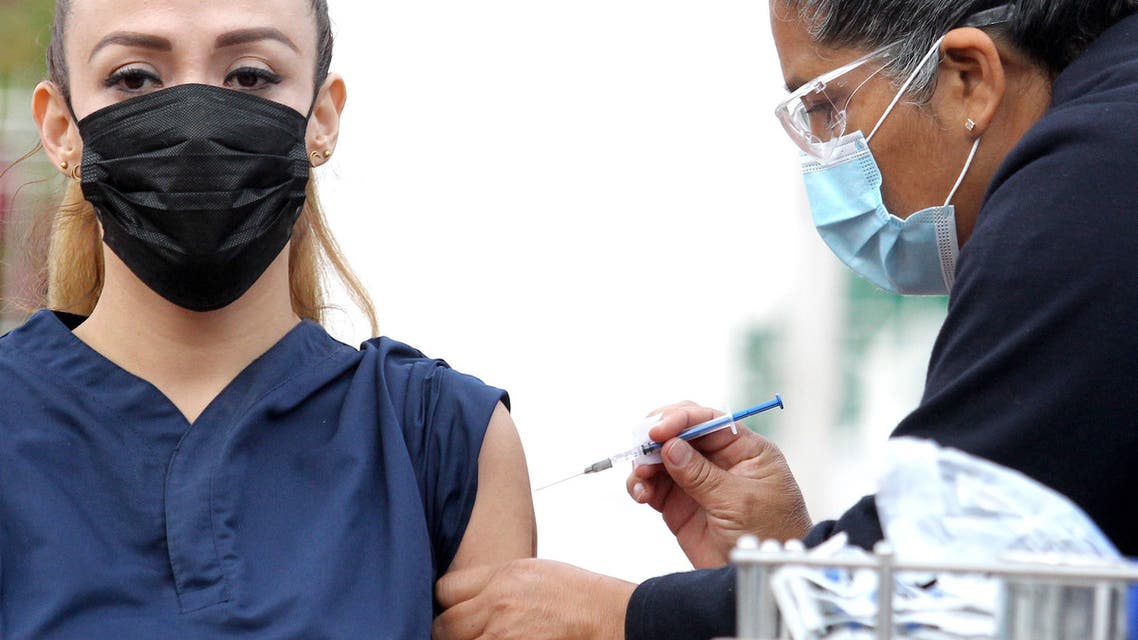 A nurse administrates a Pfizer-BioNTech Covid-19 vaccine to 37-year-old doctor Melissa Zapiain, during the start of vaccination against the SARS-CoV-2 virus to medical personnel of the General Hospital of the West Zoquipan in Zapopan, Jalisco state, Mexico, on January 13, 2021. (AFP)
