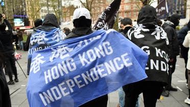 Protesters gather with banners at an event organised by Justitia Hong Kong to mourn the loss of Hong Kong's political freedoms, in Leicester Square, central London on December 12, 2020. Britain expressed alarm on Friday after Hong Kong media tycoon and Beijing critic Jimmy Lai, who has UK citizenship, became the most high-profile figure yet charged under a sweeping national security law.
