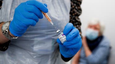 A health worker fills a syringe with a dose of the Oxford/AstraZeneca COVID-19 vaccine. (Reuters)