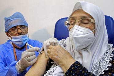 A woman receives the Sputnik-V COVID-19 vaccine at a vaccination center in Blida, south of Algiers, Algeria, Saturday, Jan. 30, 2021. (AP/Fateh Guidoum)