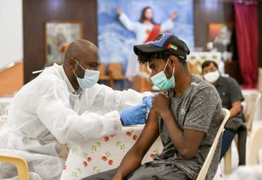 A man receives a dose of a vaccine against the coronavirus at St. Paul's Church in Abu Dhabi. (Reuters)