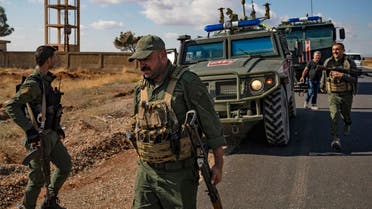 Syrian Kurdish Asayish internal security forces and Russian military police patrol the town of Darbasiyah in Syria's northeastern Hasakeh province along the Syria-Turkey border on October 30, 2019. (Delil Souleiman/AFP)