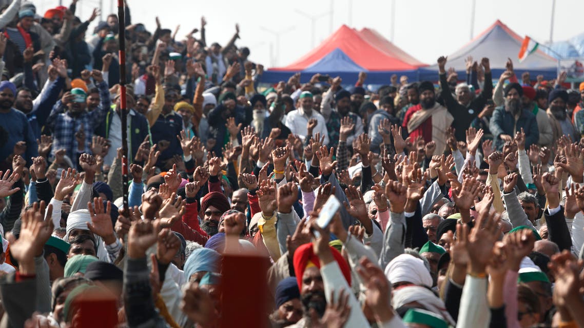 Farmers raise their hand as they shout slogans during a day-long hunger strike to protest against new farm laws, at the Delhi-Uttar Pradesh border, on the outskirts of New Delhi, India on Jan. 30, 2021. (AP)