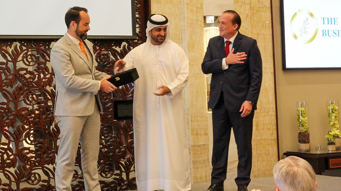 Sheikh Juma Bin Maktoum, center, gives an award to DP World SVP Ryan Quinlan, left, alongside founder of the Abrahamic Business Circle Raphael Nagel. (Supplied)