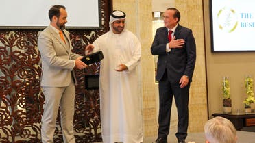 Sheikh Juma Bin Maktoum, center, gives an award to DP World SVP Ryan Quinlan, left, alongside founder of the Abrahamic Business Circle Raphael Nagel. (Supplied)