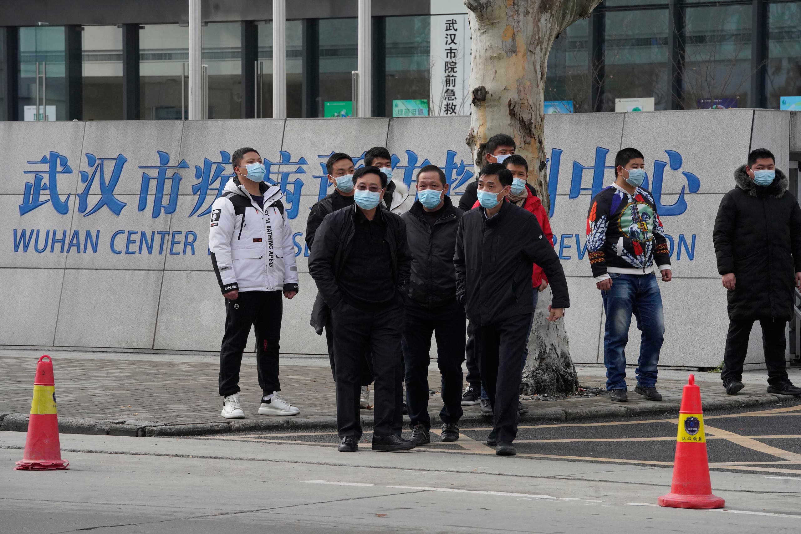 Plainclothes security personnel outside the Wuhan Center for Disease Control and Prevention ahead of the WHO team's arrival on February 1.