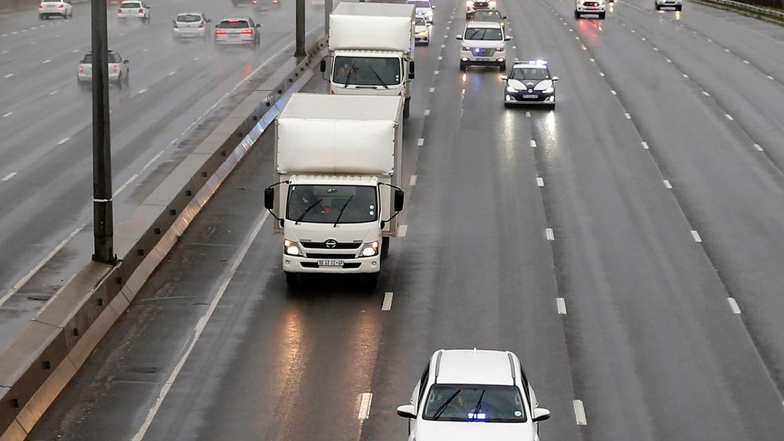 South African law enforcement agencies provide security in Johannesburg on February 1, 2021 for refrigerated trucks transporting AstraZeneca/Oxford vaccines for the Covid-19 coronavirus that arrived at OR Tambo International Airport toward where they will be stored. (AFP)