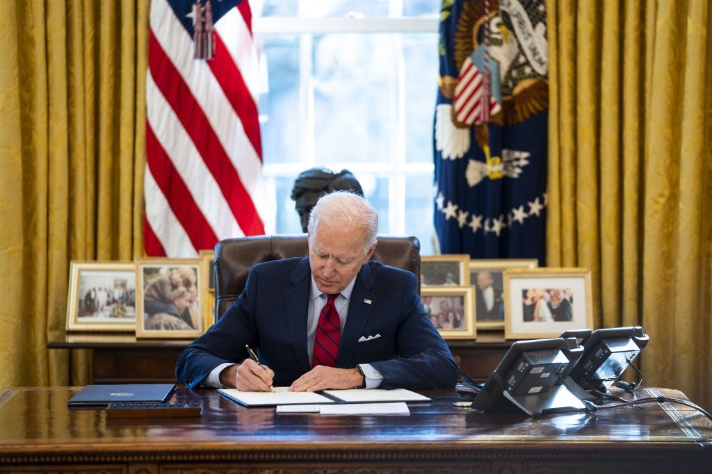 President Joe Biden signs executive actions in the Oval Office of The White House on January 28, 2021 in Washington, DC. (File photo: AFP)