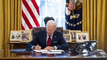 President Joe Biden signs executive actions in the Oval Office of the White House on January 28, 2021 in Washington, DC.  (AFP)