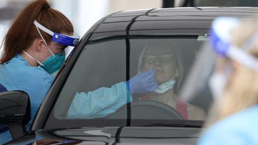A medical worker swabs a member of the public at the Bondi Beach drive-through coronavirus disease (COVID-19) testing centre as the city experiences an outbreak in Sydney, Australia, December 21, 2020. (Reuters)