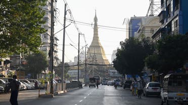People walk next to Shwedagon Pagoda on an empty road in Yangon on February 1, 2021, as Myanmar's military detained the country's de facto leader Aung San Suu Kyi and the country's president in a coup.  (File photo: AFP)