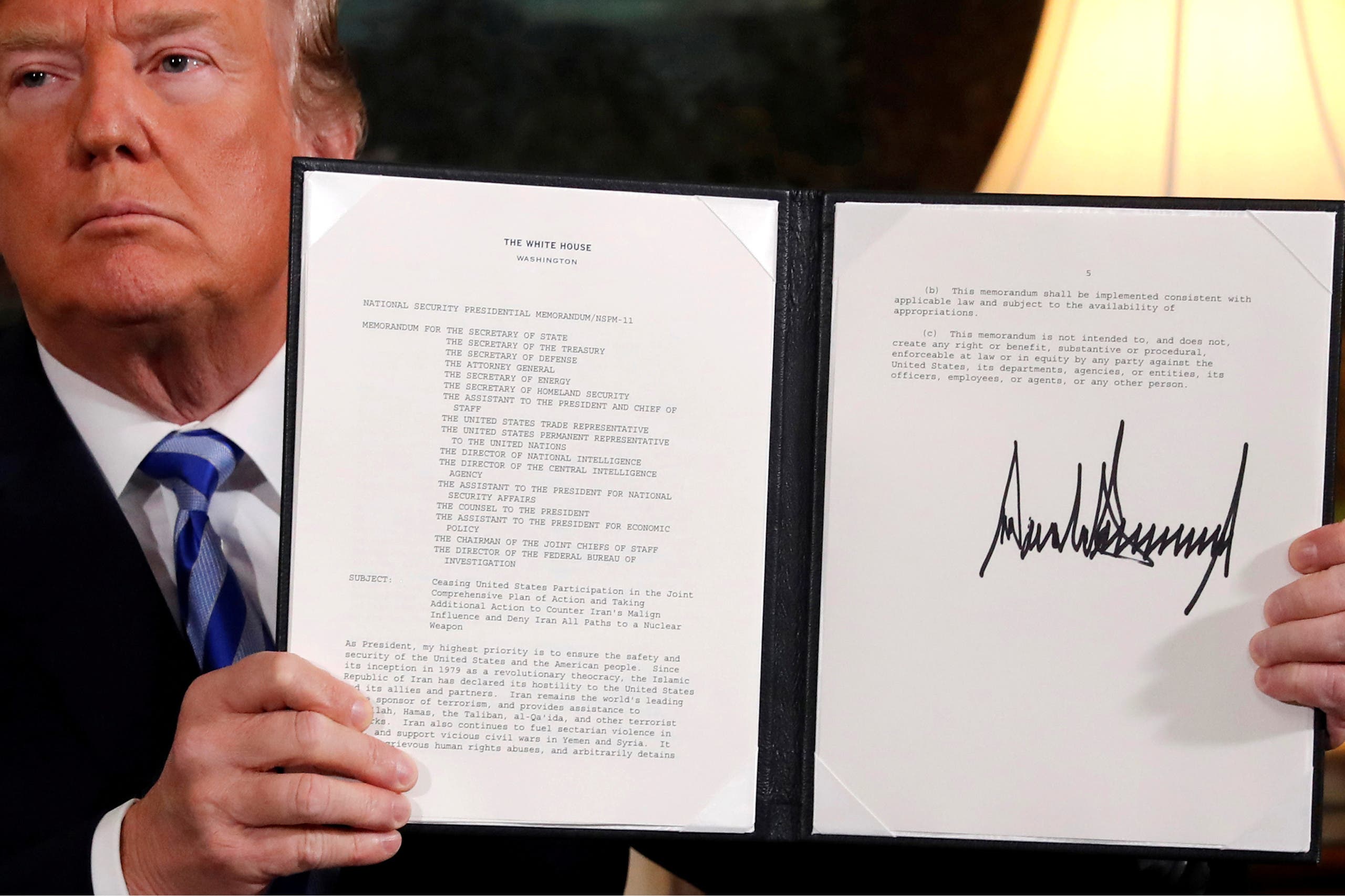 Former US President Donald Trump holds up a proclamation declaring his intention to withdraw from the JCPOA Iran nuclear agreement after signing it in the Diplomatic Room at the White House in Washington, US May 8, 2018. (File photo: Reuters)