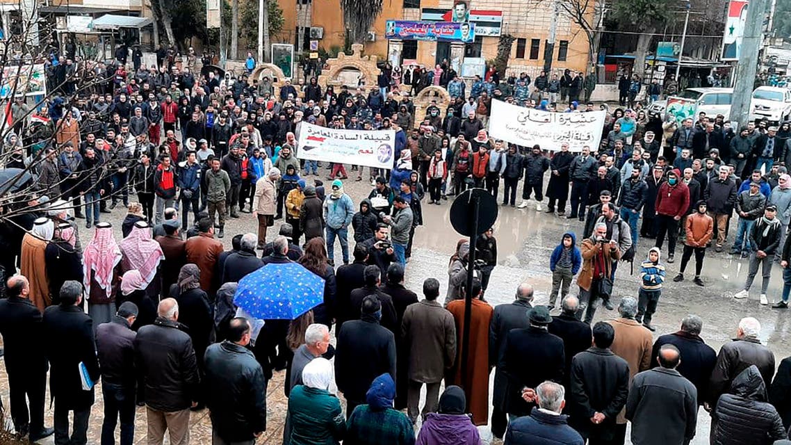 In this photo released by the Syrian official news agency SANA, pro-government demonstrators protest the siege on their neighborhood by Kurdish security forces, in Hassakeh, Syria, Sunday, Jan. 31, 2021. The state news agency SANA said one Syrian was killed and four injured after Kurdish security forces opened fire at pro-government demonstrators in Hassakeh. A Kurdish-run news agency, Hawar, said security forces at a checkpoint in the city had come under fire, prompting its members to respond to the source of fire that led to the death of a government security member. (SANA via AP)