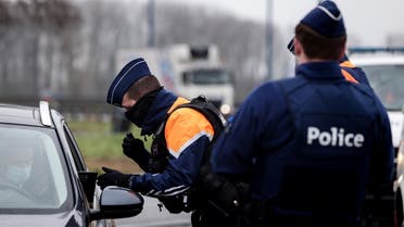 Belgian police officers perform road checks on January 27, 2021 at a  border crossing with France. (Kenzo Tribouillard/AFP)