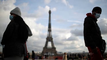 People, wearing protective face masks, walk at Trocadero square near the Eiffel Tower in Paris amid the coronavirus disease (COVID-19) outbreak in France, January 22, 2021. (Reuters)