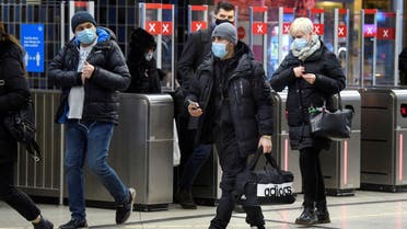 Passengers wearing protective masks enter an underground railway station, amid the spread of the coronavirus , in Stockholm, Sweden. (Reuters)