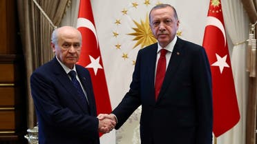 This handout photo released by the Turkish Presidential Press Service shows Devlet Bahceli (L) with Turkey’s President Recep Tayyip Erdogan (R) before a meeting at the presidential palace in Ankara, on June 27, 2018. (Kayhan OZER/AFP)