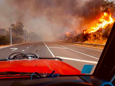 In this photo provided by Department of Fire and Emergency Services, flames approach a road at Wooroloo, near Perth, Australia, Monday, Feb. 1, 2021. (AP)