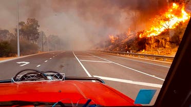In this photo provided by Department of Fire and Emergency Services, flames approach a road at Wooroloo, near Perth, Australia, Monday, Feb. 1, 2021. (AP)