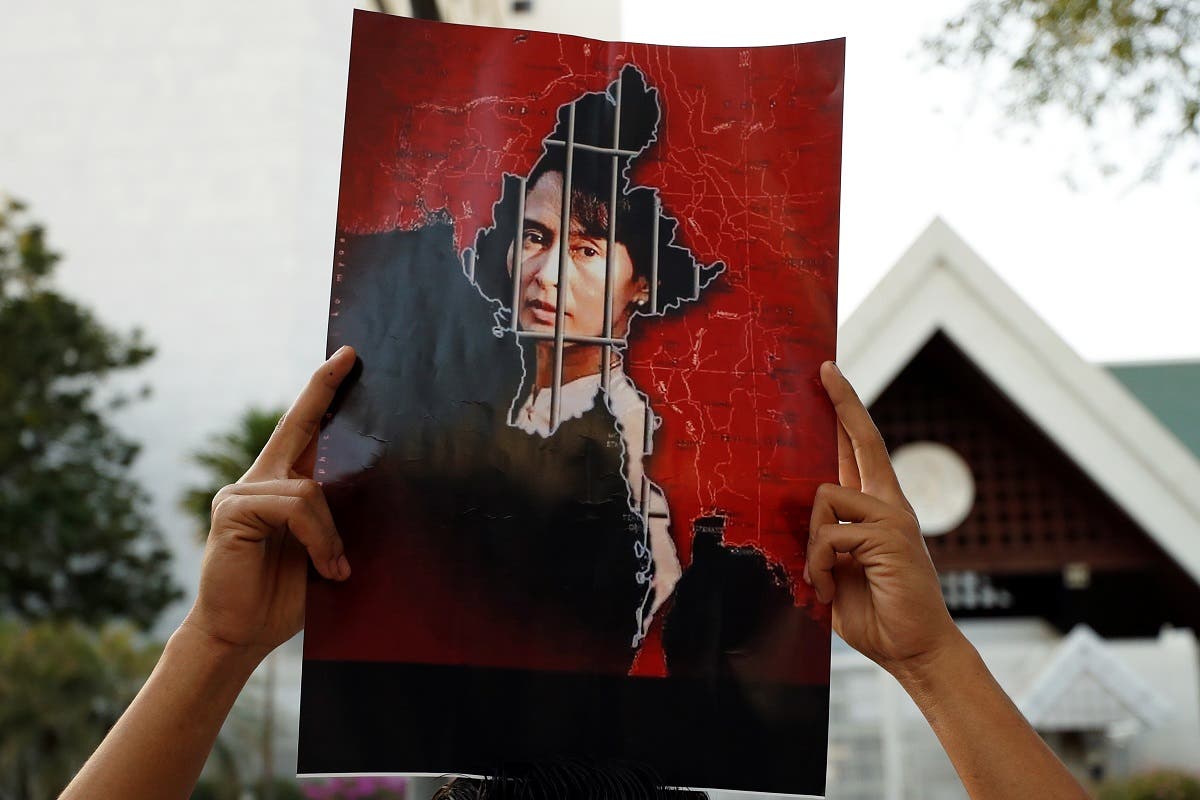 A Myanmar citizen holds up a picture of leader Aung San Suu Kyi after the military seized power in a coup in Myanmar, outside United Nations venue in Bangkok, Thailand February 2, 2021. (Reuters)