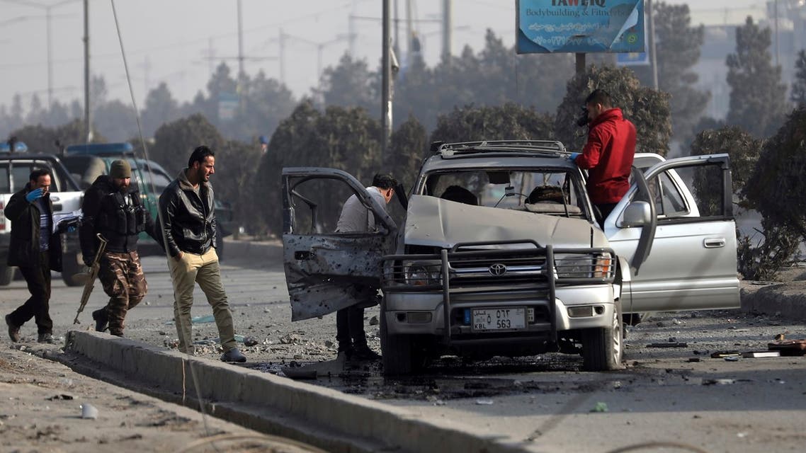 Security personnel inspect the site of a bomb attack in Kabul, Afghanistan, Tuesday, Feb. 2, 2021. A roadside bomb exploded Tuesday in the capital, Kabul, wounding several people. (AP Photo/Rahmat Gul)