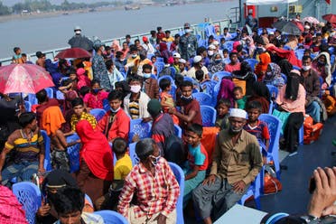 Rohingya refugees sit on a Bangladesh Navy ship as they are relocated to the controversial flood-prone island Bhashan Char in the Bay of Bengal, in Chittagong on December 29, 2020. (AFP)